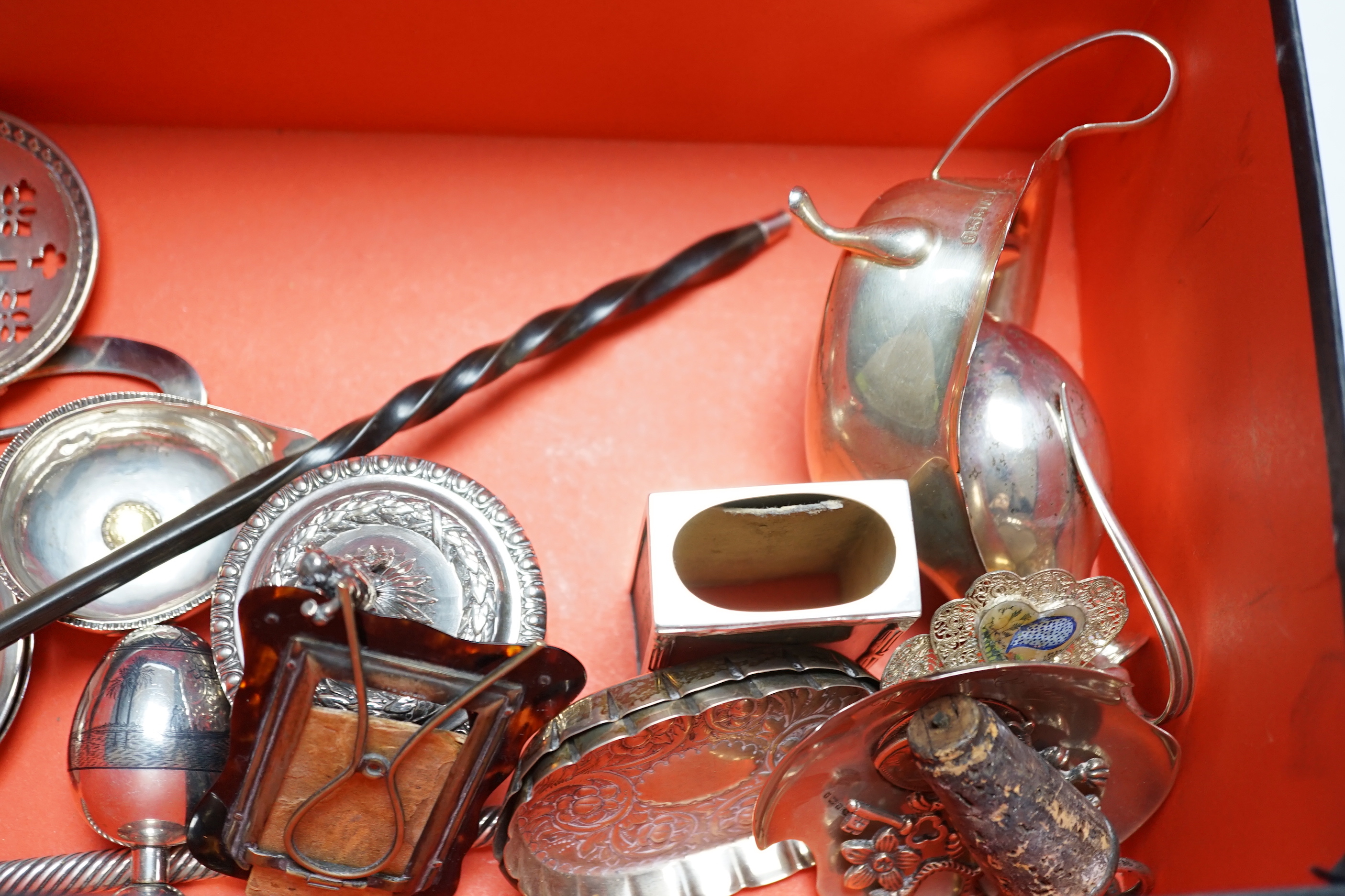 Assorted small silver including pair of silver sauceboats, a small jug and vase, a salts bottle, condiments, photograph frames, a matchbox sleeve, etc.